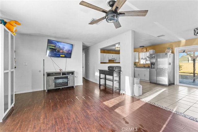 unfurnished living room with ceiling fan and hardwood / wood-style floors