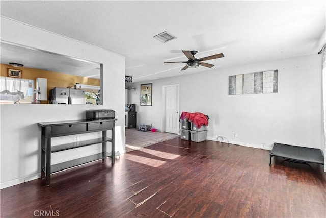 living area featuring ceiling fan and wood-type flooring