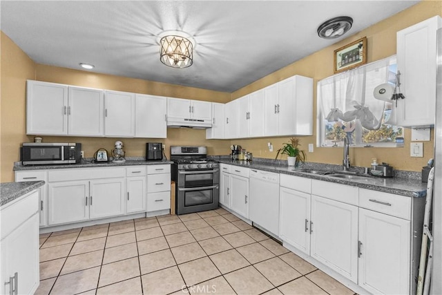 kitchen featuring stainless steel appliances, white cabinetry, and sink