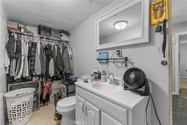 bathroom with hardwood / wood-style floors, toilet, and vanity