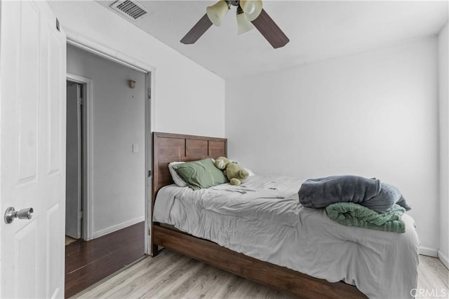 bedroom with ceiling fan and light hardwood / wood-style floors