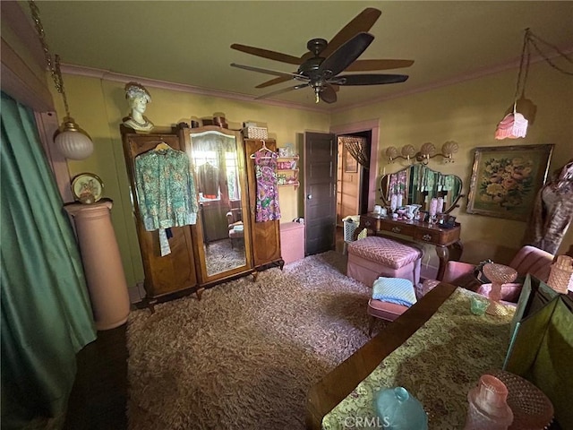 bedroom featuring ceiling fan, ornamental molding, and carpet flooring