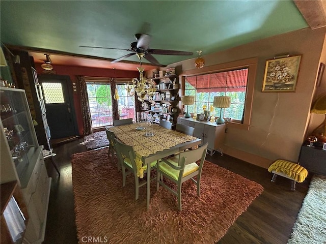 dining space with ceiling fan and dark wood-type flooring