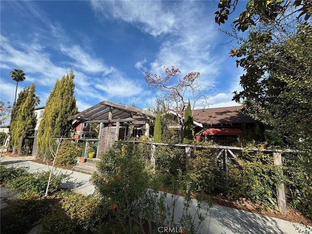 view of home's community featuring a pergola