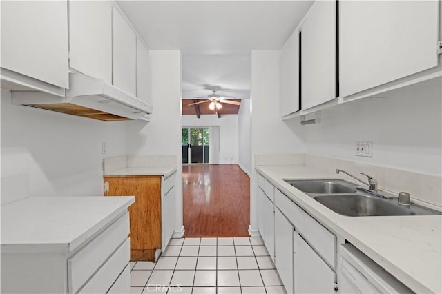 kitchen with white cabinets, dishwasher, sink, light tile patterned flooring, and ceiling fan