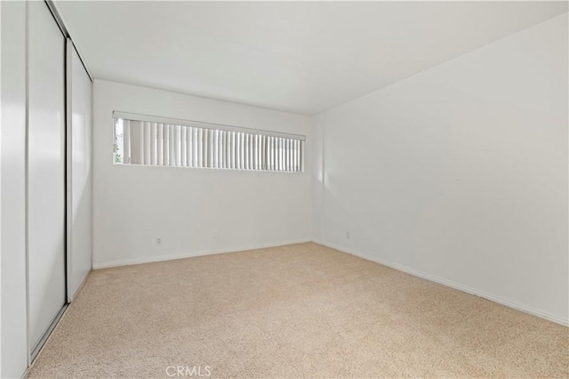 spare room with light carpet