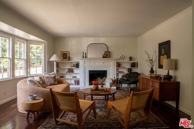 living room with dark wood-type flooring and a brick fireplace