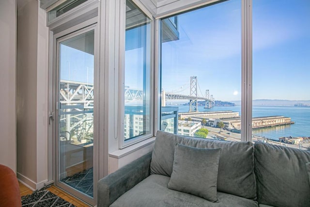 interior space featuring a water view, plenty of natural light, and hardwood / wood-style flooring