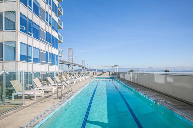 view of swimming pool featuring a water view