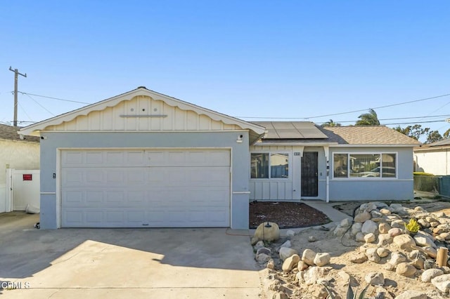 ranch-style house with solar panels and a garage