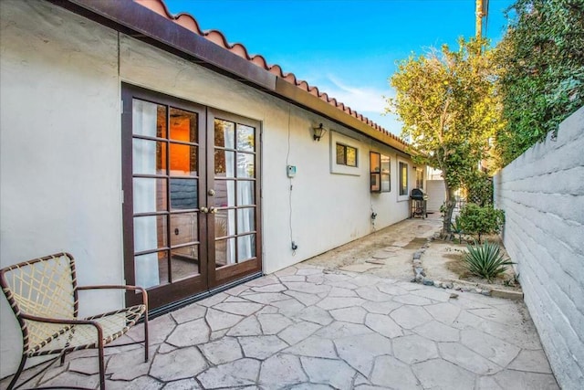 view of patio / terrace featuring a grill and french doors