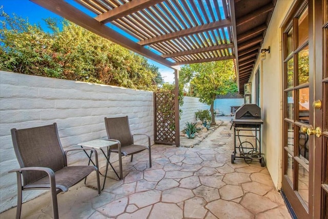 view of patio with grilling area and a pergola