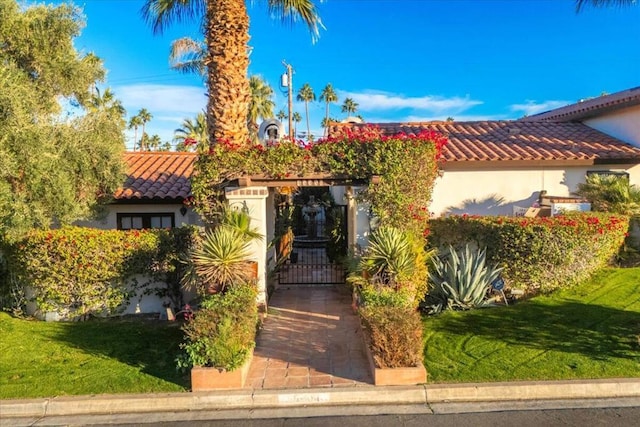 mediterranean / spanish home featuring a front yard