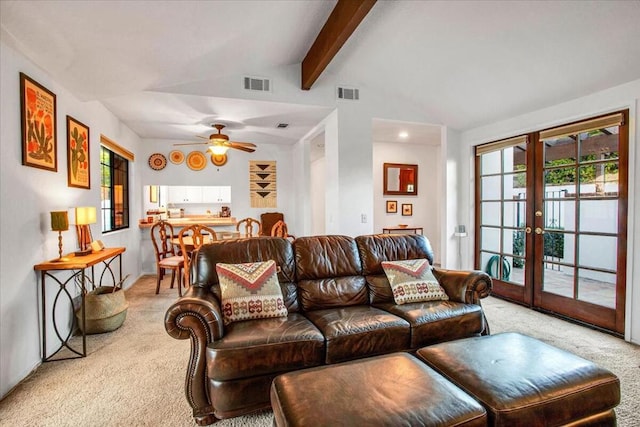 living room with ceiling fan, carpet flooring, french doors, and lofted ceiling with beams