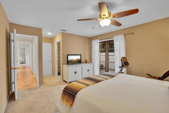 bedroom featuring ceiling fan, light colored carpet, and access to exterior