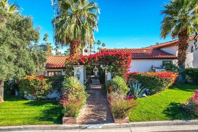 mediterranean / spanish house featuring a front lawn