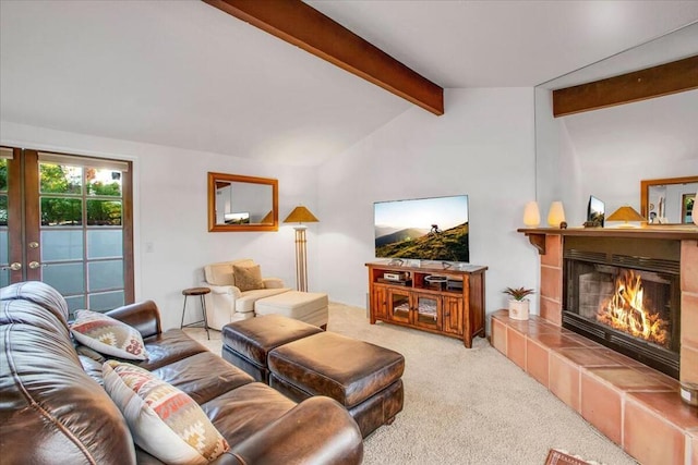 living room with carpet, a tiled fireplace, and lofted ceiling with beams