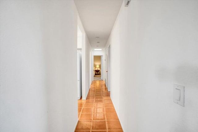 hall featuring light tile patterned floors