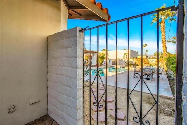 view of gate featuring a patio area