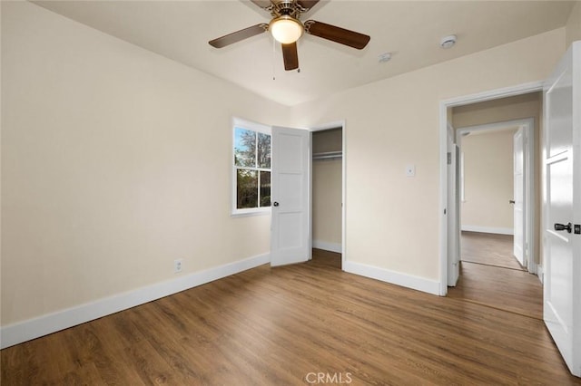 unfurnished bedroom with ceiling fan, a closet, and hardwood / wood-style floors