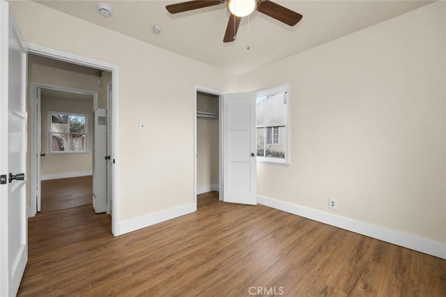 unfurnished bedroom with ceiling fan, hardwood / wood-style flooring, and a closet