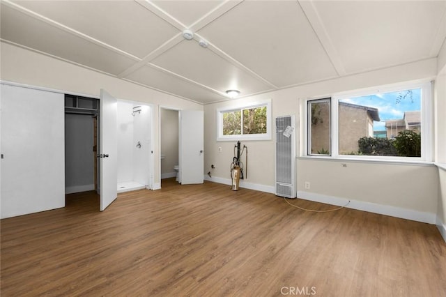 unfurnished bedroom featuring hardwood / wood-style flooring and coffered ceiling