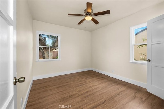 unfurnished room featuring ceiling fan, wood-type flooring, and a healthy amount of sunlight