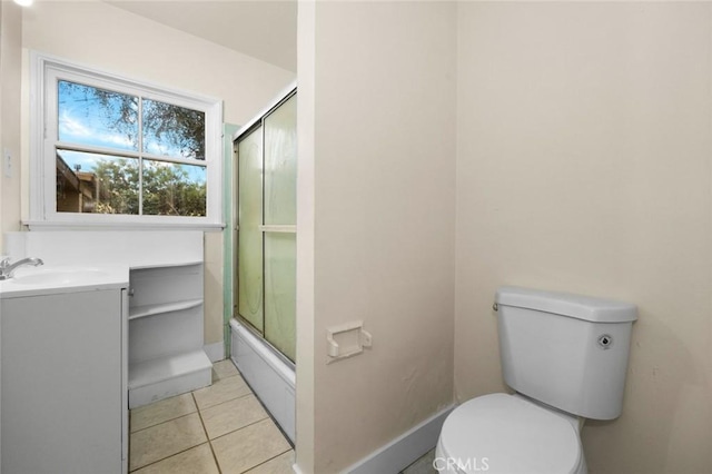 full bathroom featuring toilet, tile patterned floors, vanity, and enclosed tub / shower combo