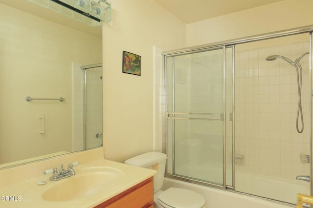 full bathroom with toilet, vanity, and shower / bath combination with glass door