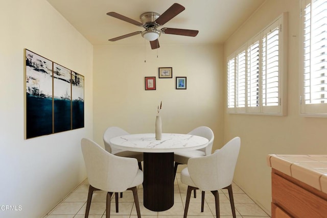 tiled dining area featuring ceiling fan