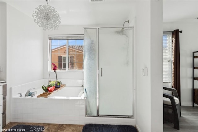 bathroom featuring vanity, a wealth of natural light, and plus walk in shower