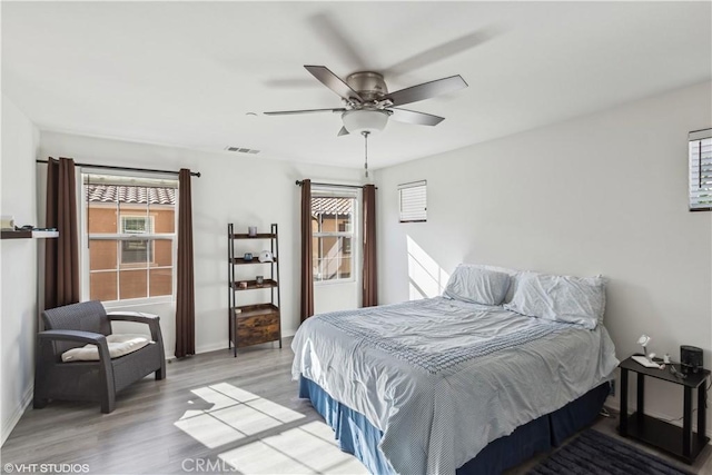 bedroom with ceiling fan and wood-type flooring