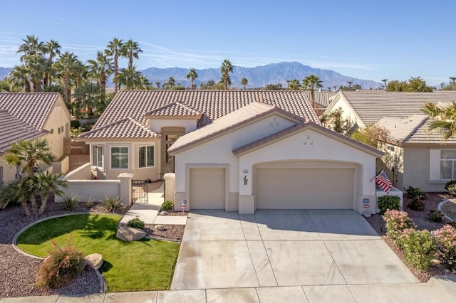 mediterranean / spanish-style home featuring a garage and a mountain view