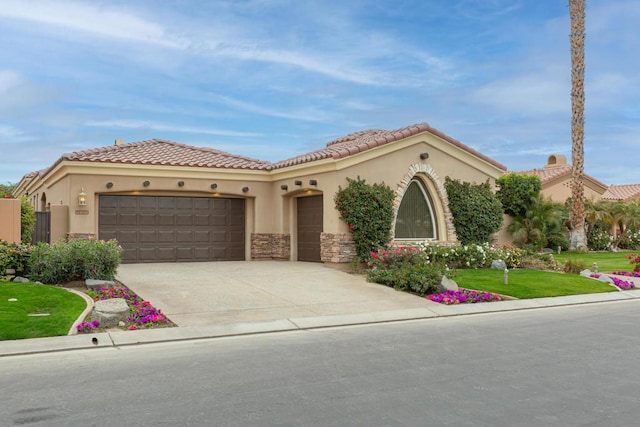 mediterranean / spanish home featuring a garage