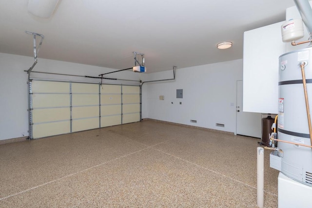 garage featuring a garage door opener, electric panel, and strapped water heater