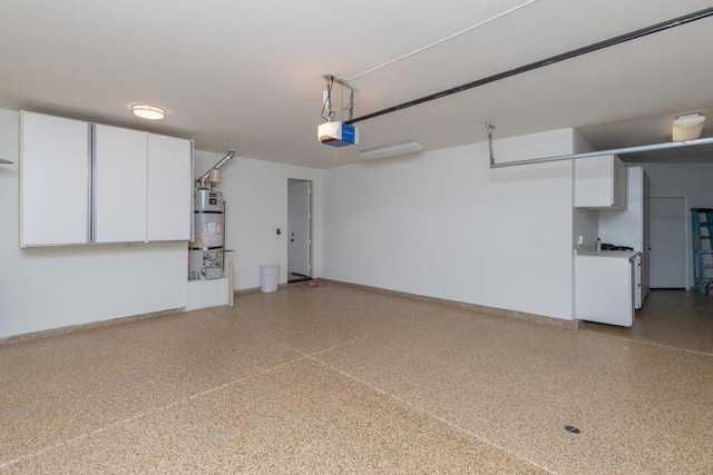 garage featuring washer / clothes dryer, strapped water heater, and a garage door opener