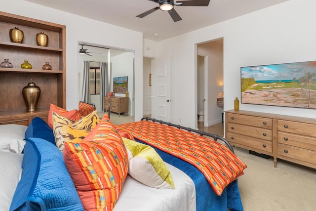 bedroom with light carpet, ceiling fan, and a closet