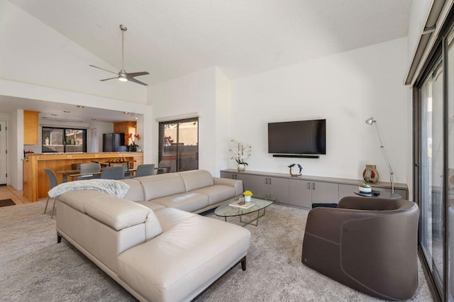 living room with ceiling fan and lofted ceiling