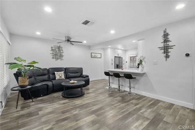 living room with ceiling fan and hardwood / wood-style flooring