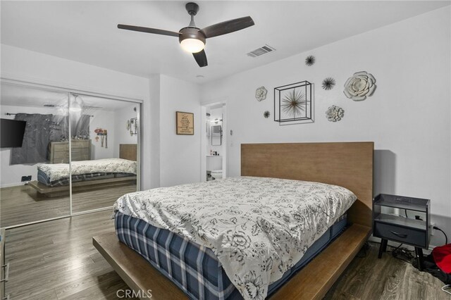 bedroom featuring a closet, dark hardwood / wood-style flooring, and ceiling fan