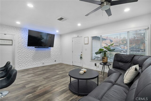 living room featuring ceiling fan and hardwood / wood-style floors