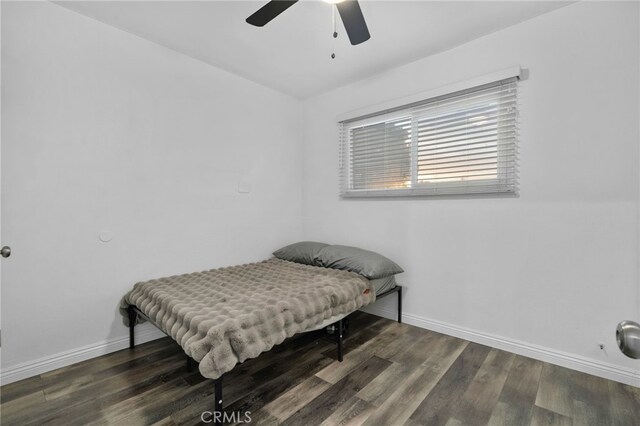 bedroom with ceiling fan and dark hardwood / wood-style floors