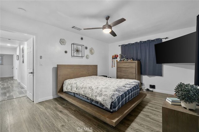 bedroom with ceiling fan and hardwood / wood-style floors