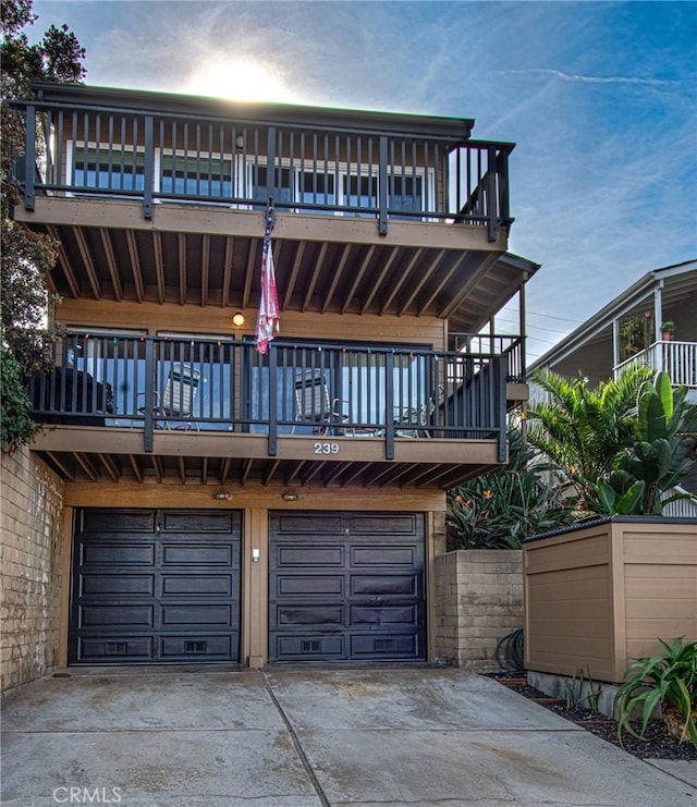 view of front facade featuring a balcony and a garage