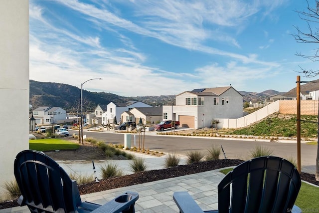 view of patio featuring a mountain view and a garage