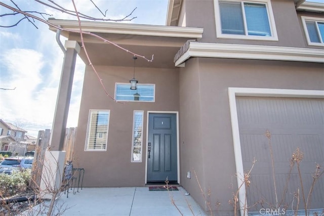 doorway to property with a garage