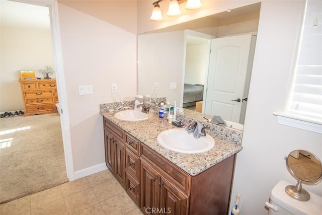 bathroom with tile patterned flooring, vanity, and toilet