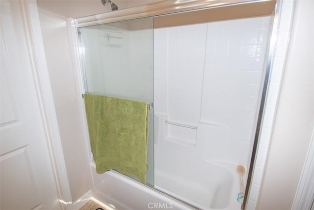 bathroom with shower / bath combination with glass door