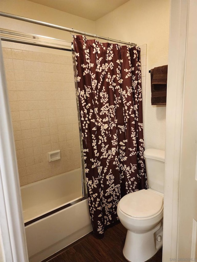 bathroom with toilet, shower / tub combo with curtain, and hardwood / wood-style flooring