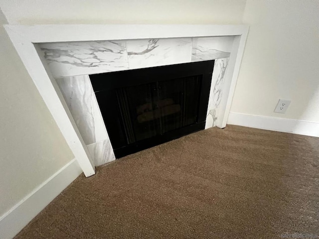 interior details with carpet floors and a fireplace